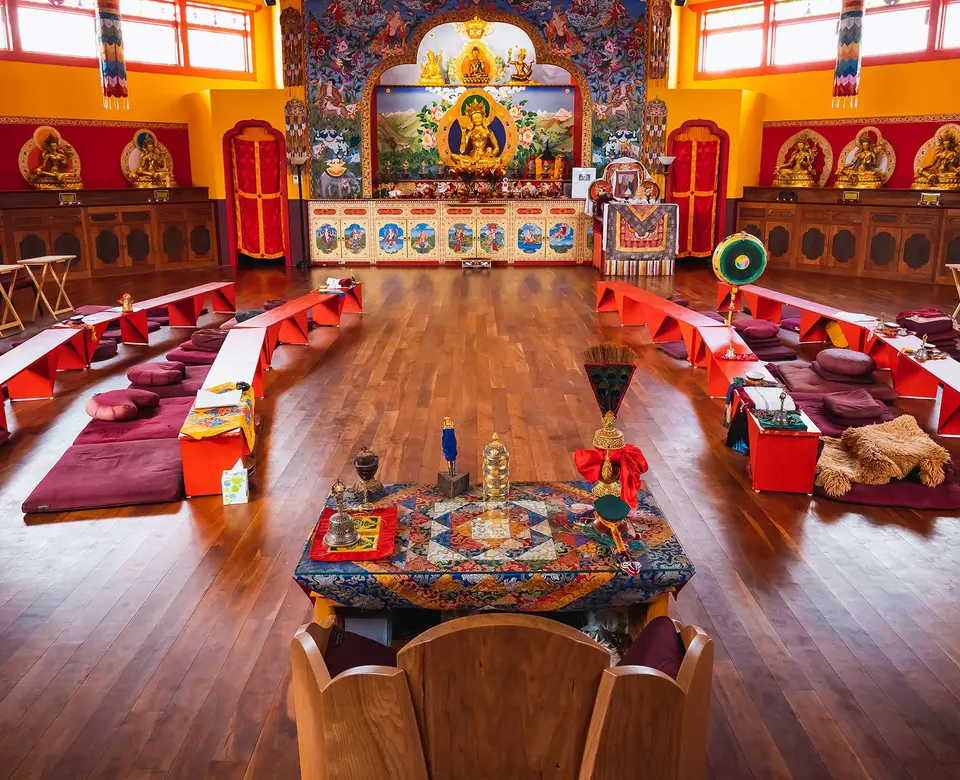The shrine room inside the Tara Temple, with meditation cushions set around the altar